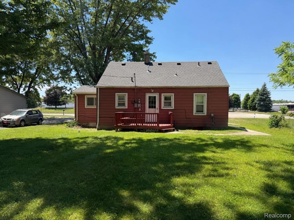 6237 Inkster Road Taylor, MI 48180 - Photo 3 of 14 Red-sided residence with white trim windows and a dark shingle roof