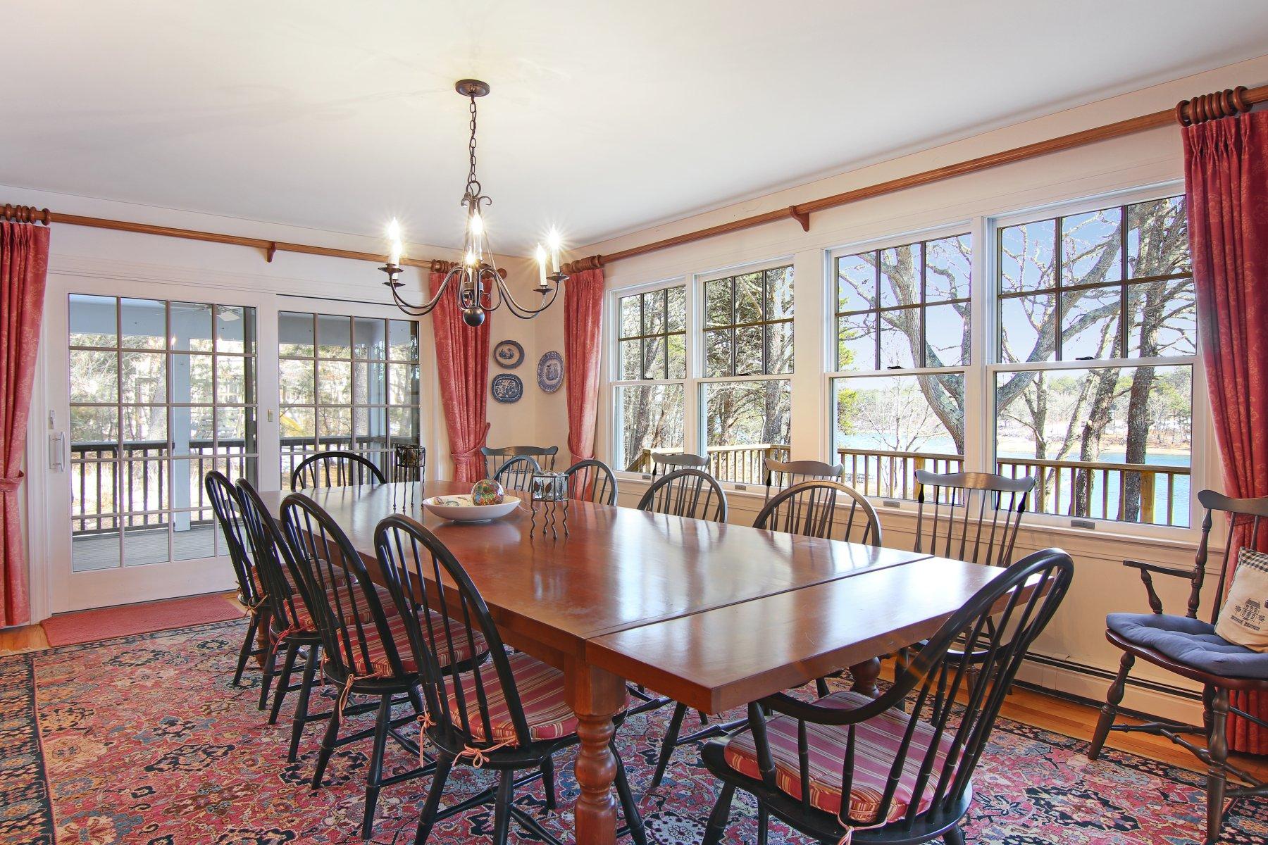 16 Thayer Lane Orleans, MA 02653 - Photo 12 of 35 a dining room with furniture a chandelier and wooden floor