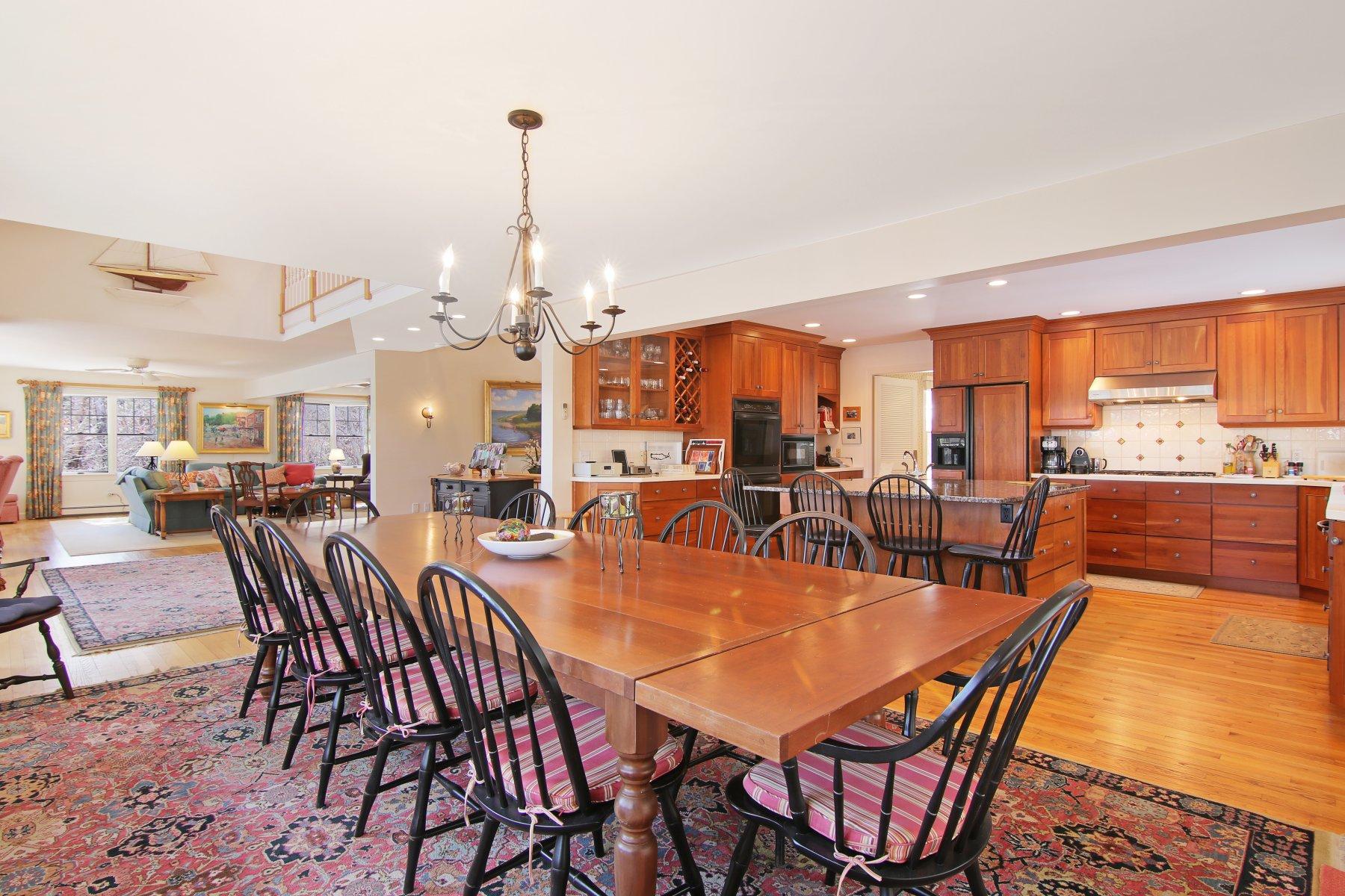 16 Thayer Lane Orleans, MA 02653 - Photo 13 of 35 a dining room with furniture a rug a potted plant and a painting