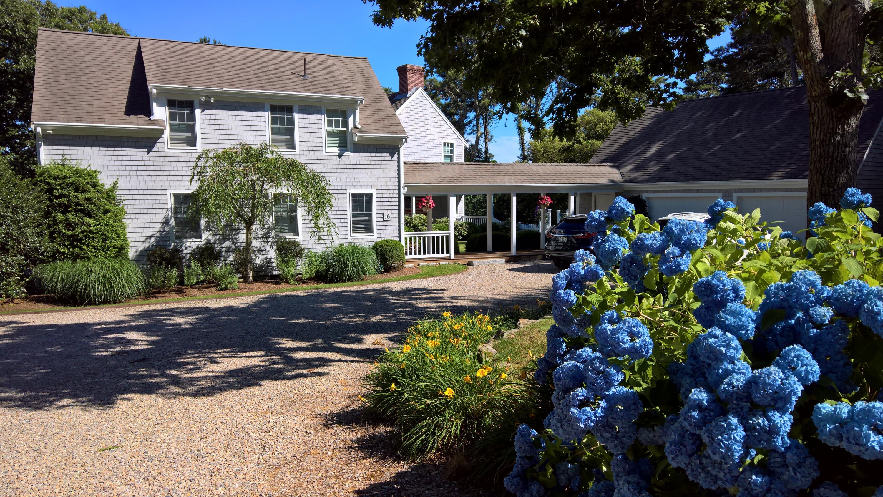 16 Thayer Lane Orleans, MA 02653 - Photo 22 of 35 a front view of a house with a yard and a fountain