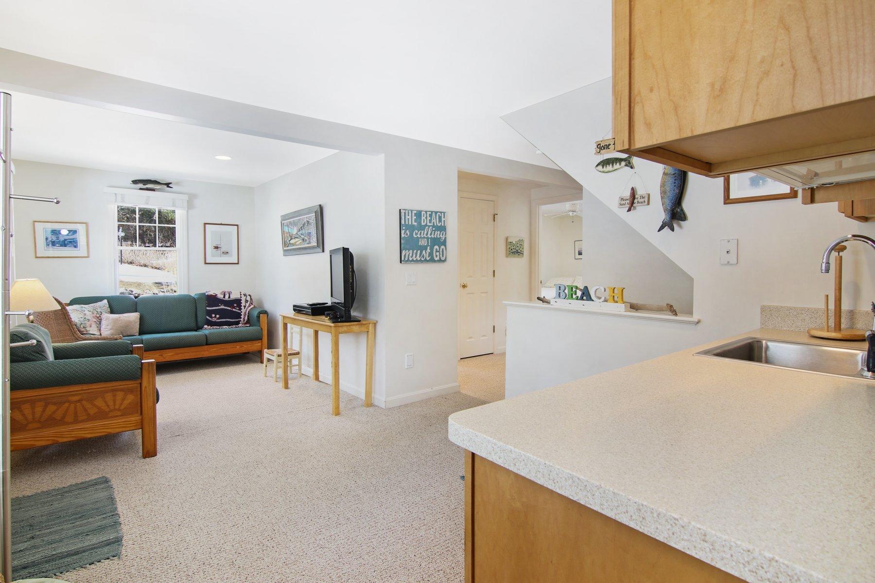 16 Thayer Lane Orleans, MA 02653 - Photo 33 of 35 a bedroom with a bed and a view of kitchen