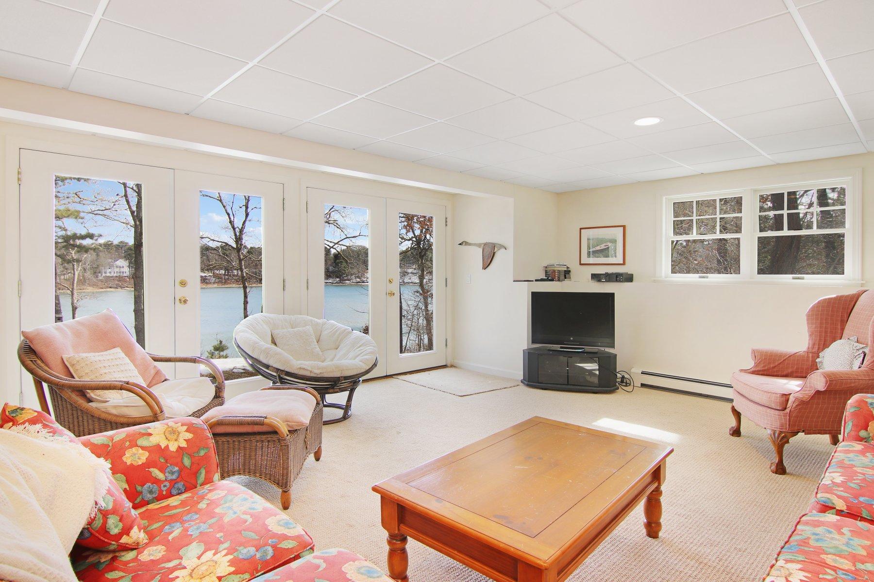 16 Thayer Lane Orleans, MA 02653 - Photo 35 of 35 a living room with furniture a flat screen tv and a refrigerator
