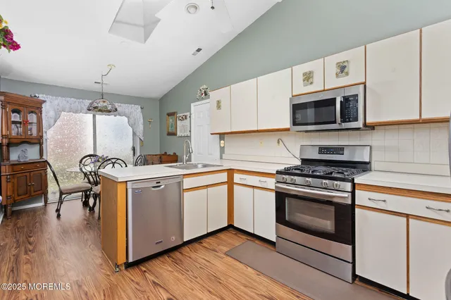 a view of a dining room with furniture and chandelier