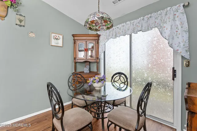 a view of a dining room with furniture and a chandelier