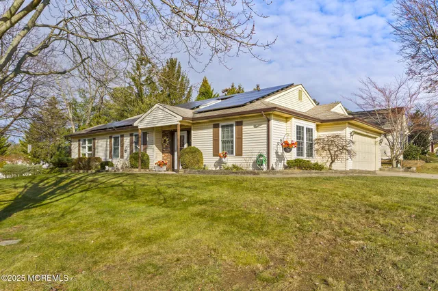 a front view of a house with a garden