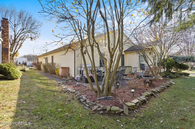 a view of a patio with table and chairs and potted plants