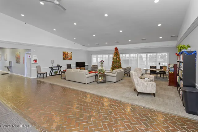 a view of room with windows book shelves