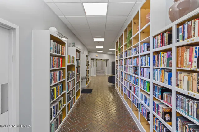 a large room with pool table and windows
