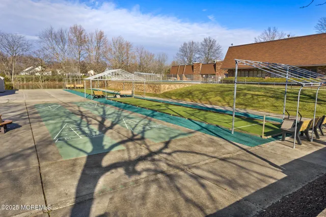 a view of a yard with furniture and trees in the background