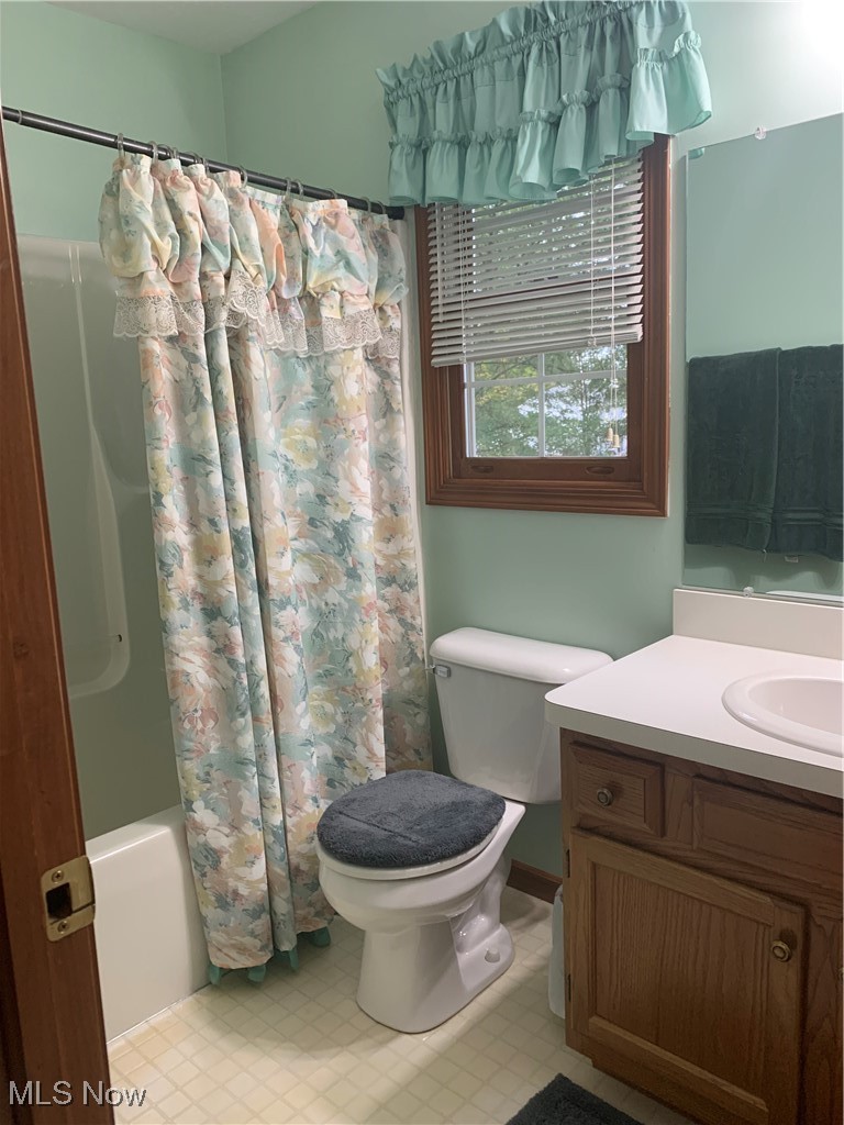9046 Shepard Road Macedonia, OH 44056 - Photo 27 of 33 Hall bathroom with vanity, toilet, and shower / tub combo with curtain