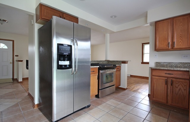 1269 East Street Crete, IL 60417 - Photo 8 of 24 a kitchen with stainless steel appliances granite countertop a refrigerator and a stove