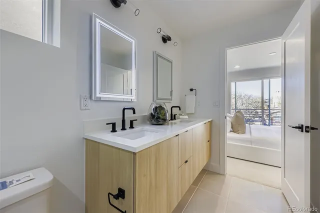 a bathroom with a sink a toilet and mirror