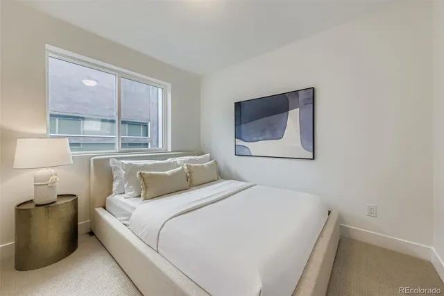 a bedroom with a bed and a couch