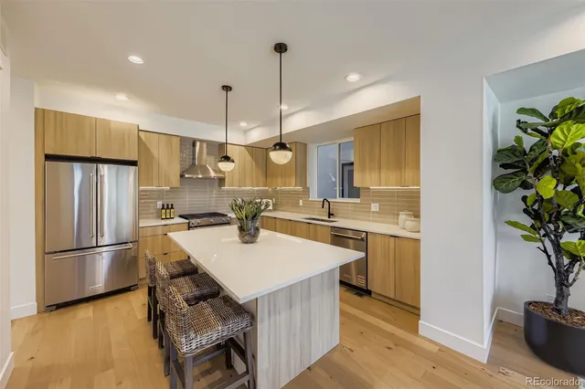 a kitchen with kitchen island a counter appliances a sink and cabinets