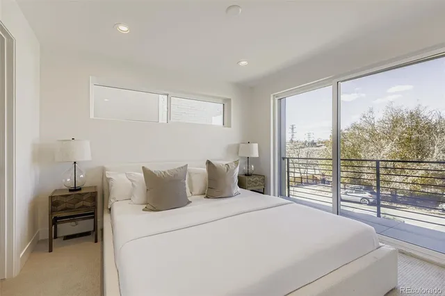 a bedroom with a large bed and a large window