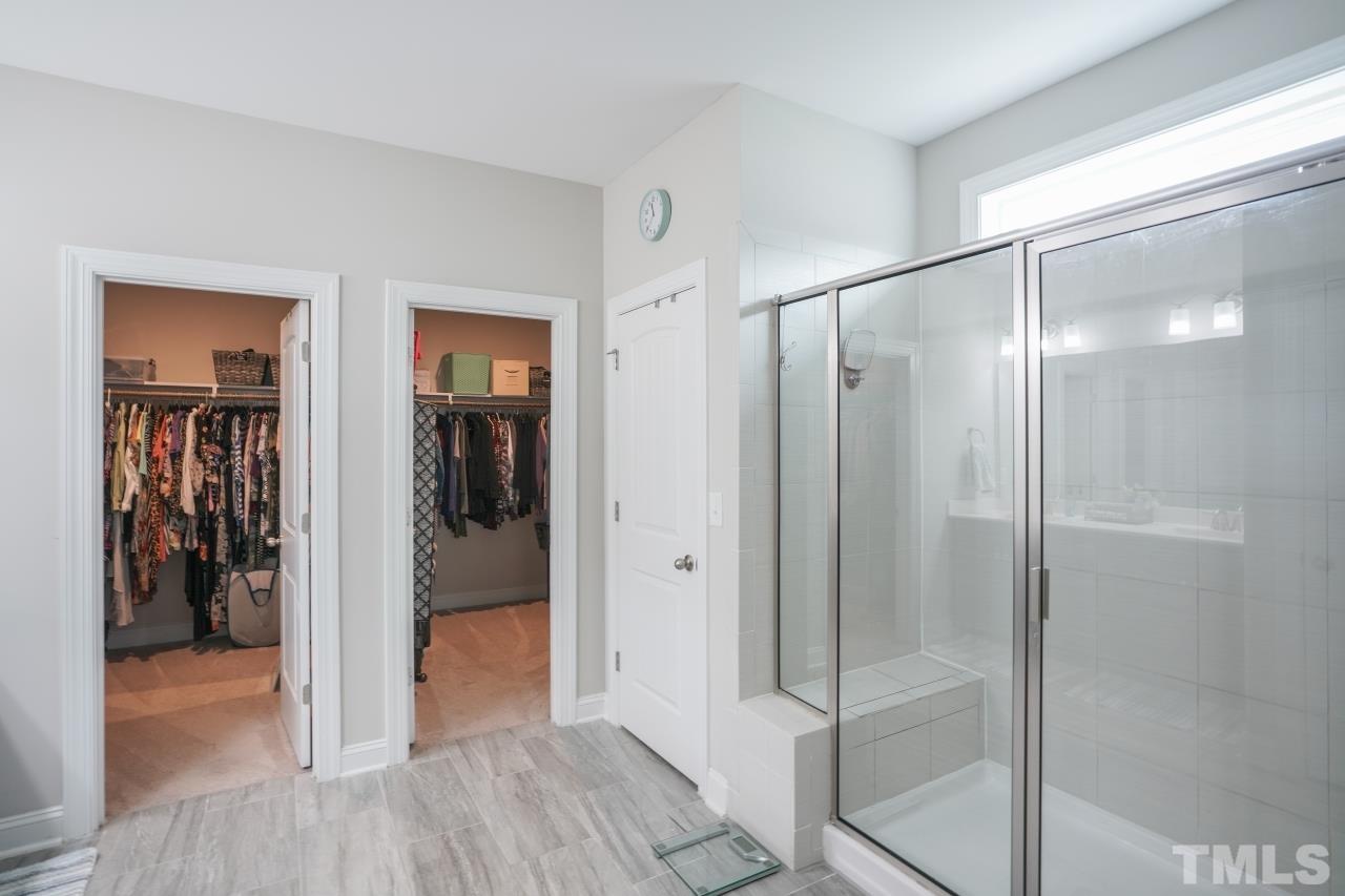 3373 Willow Green Drive Apex, NC 27502 - Photo 18 of 42 a bathroom with a glass shower door