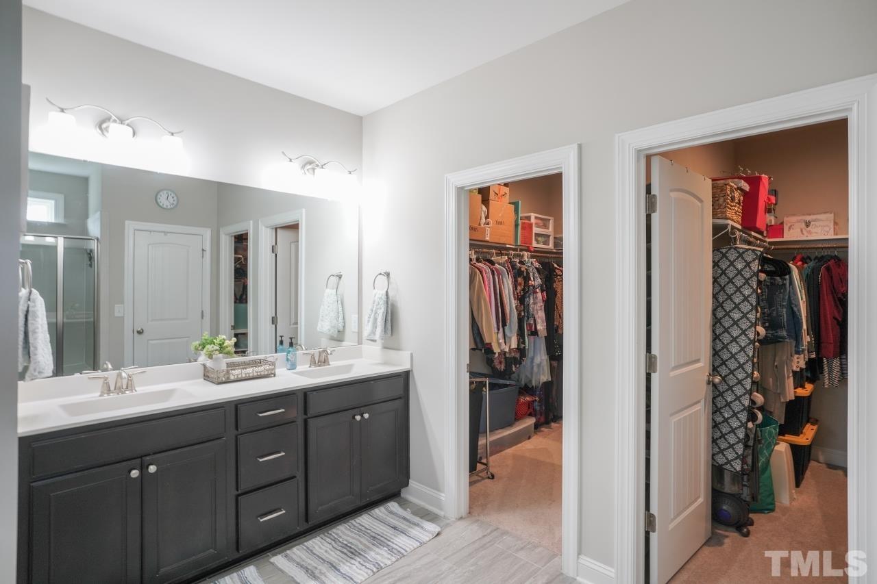 3373 Willow Green Drive Apex, NC 27502 - Photo 20 of 42 a spacious bathroom with a double vanity sink a mirror and shower