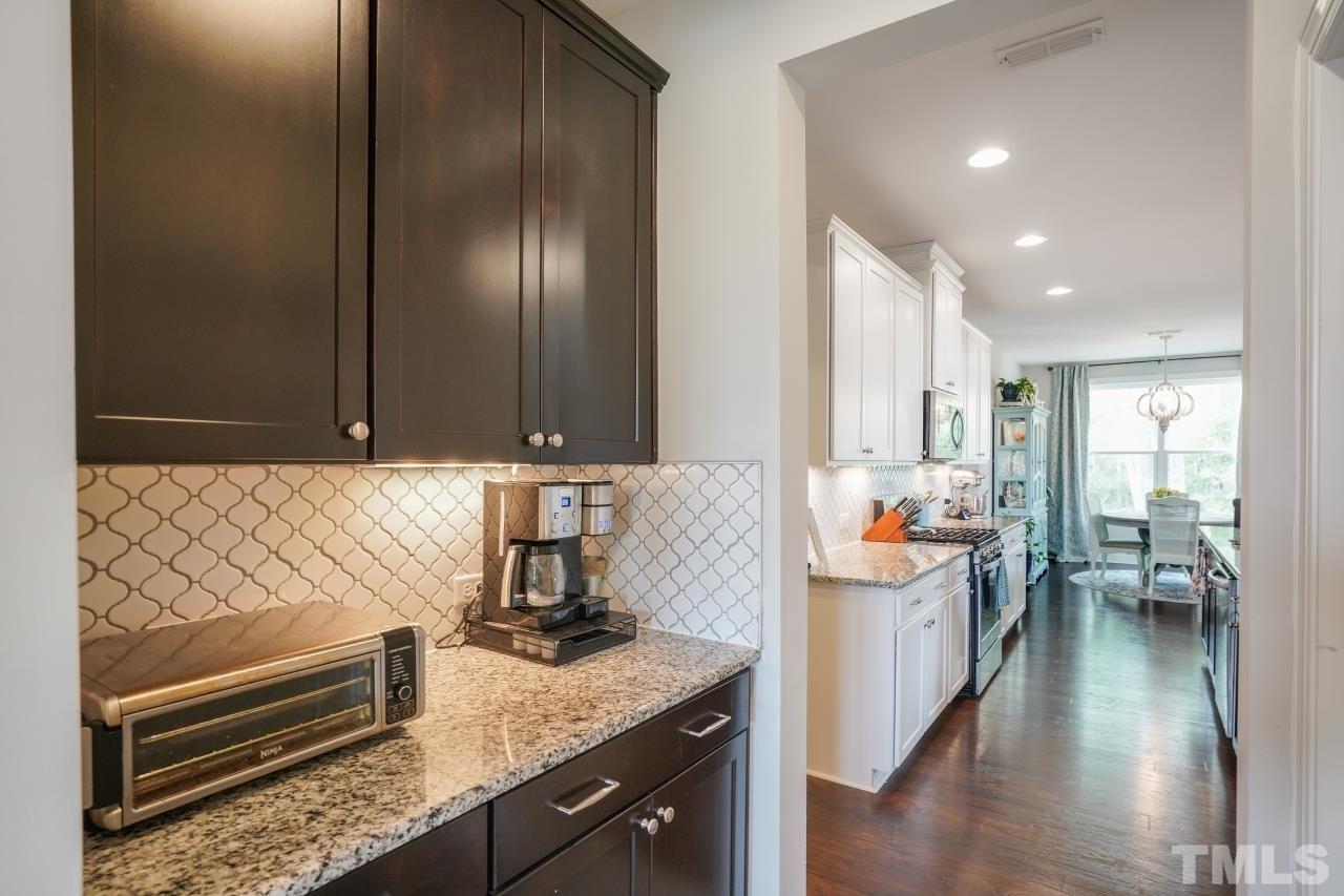 3373 Willow Green Drive Apex, NC 27502 - Photo 24 of 42 a kitchen with stainless steel appliances granite countertop a sink and cabinets