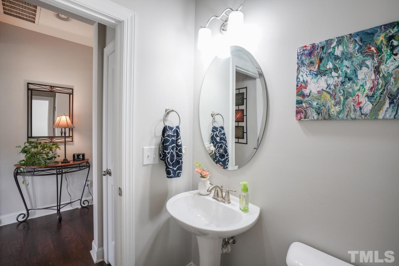 3373 Willow Green Drive Apex, NC 27502 - Photo 25 of 42 a bathroom with a sink and a mirror