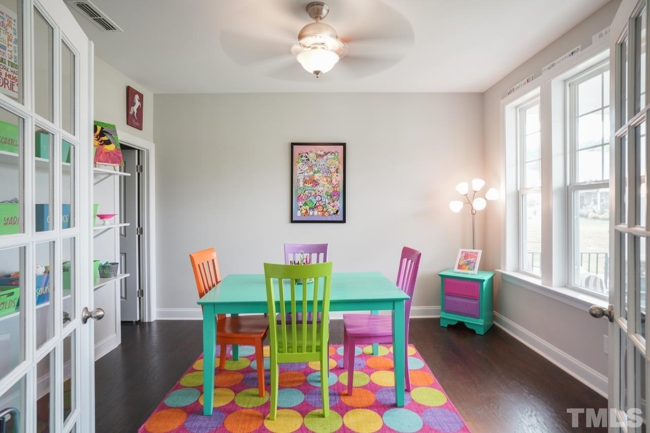 3373 Willow Green Drive Apex, NC 27502 - Photo 26 of 42 a living room with furniture and a baby crib