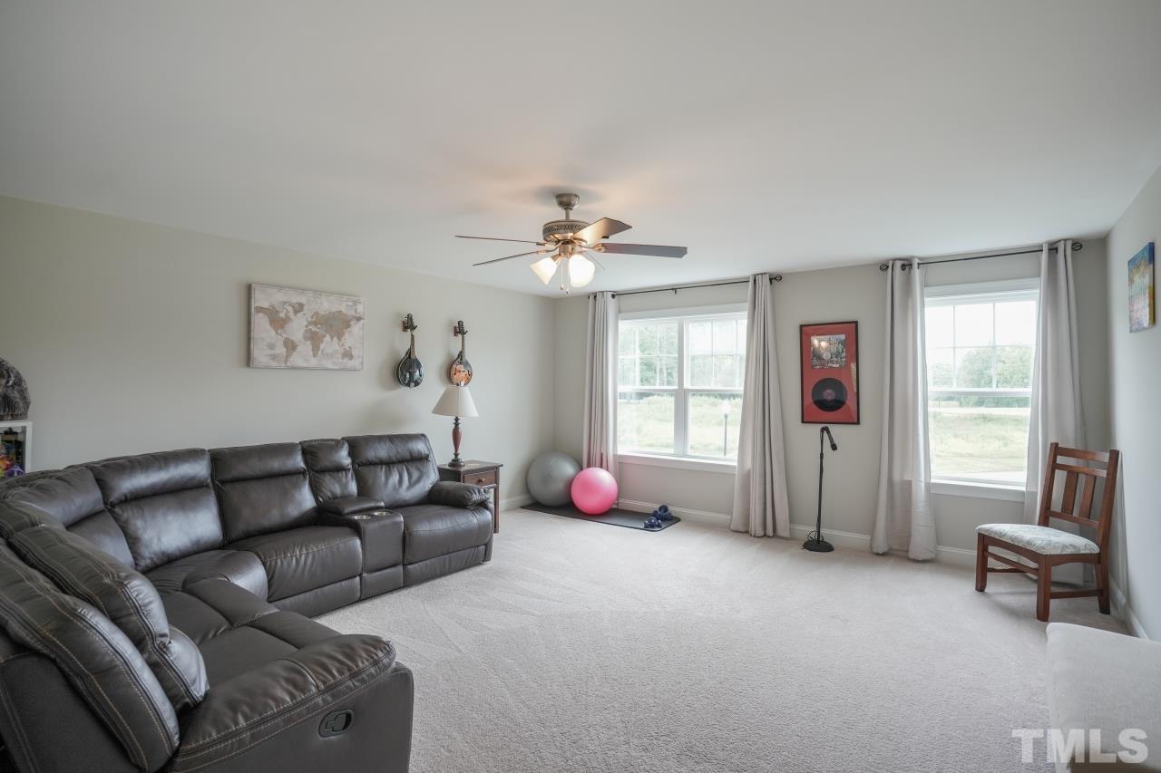 3373 Willow Green Drive Apex, NC 27502 - Photo 27 of 42 a living room with furniture and a large window