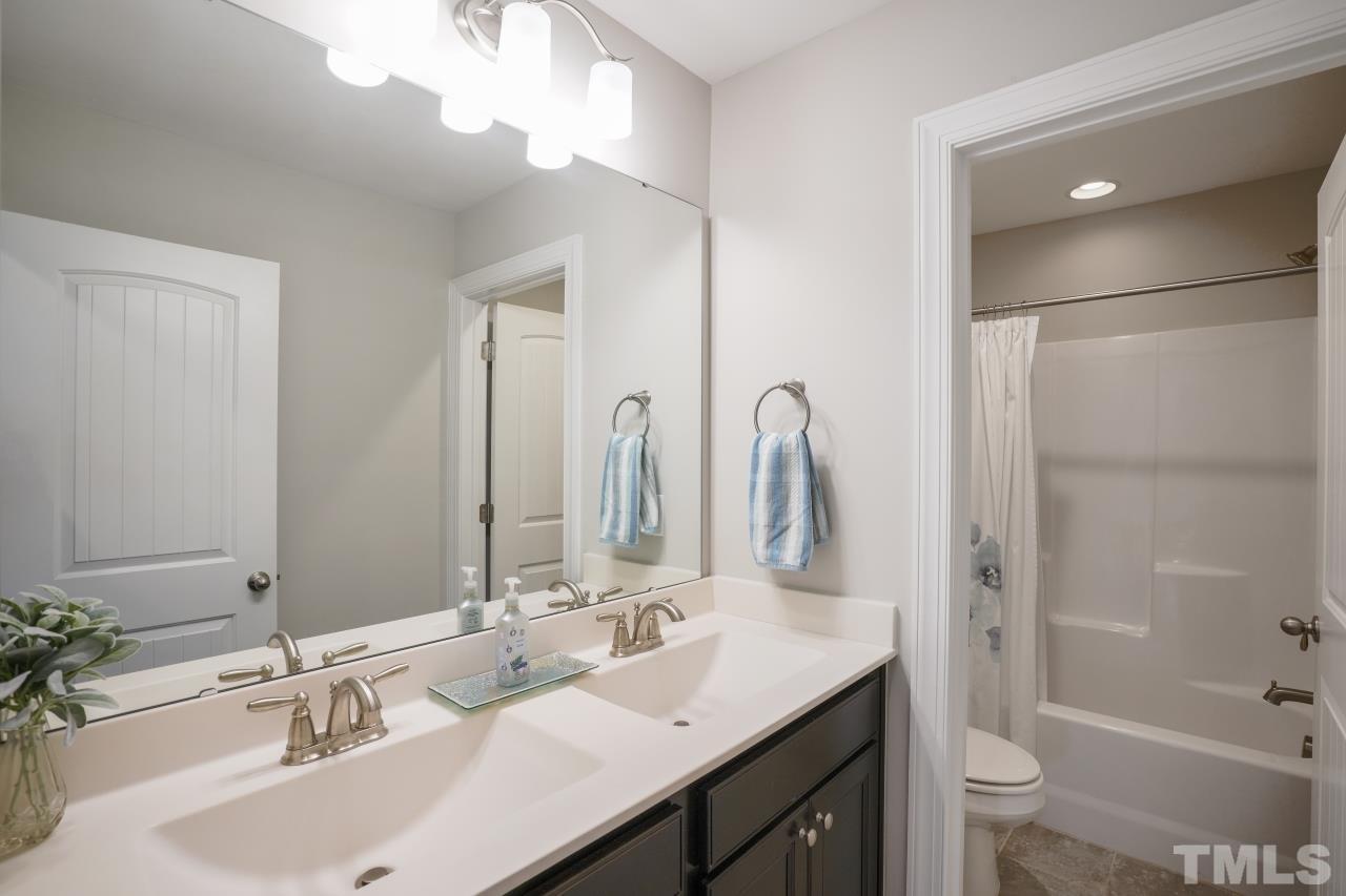 3373 Willow Green Drive Apex, NC 27502 - Photo 29 of 42 a bathroom with a double vanity sink mirror double and a bathtub