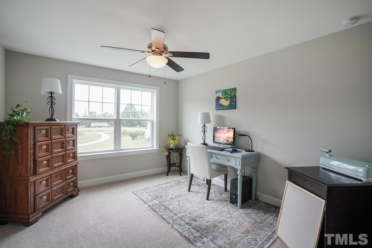 3373 Willow Green Drive Apex, NC 27502 - Photo 30 of 42 a view of a workspace with furniture and a window