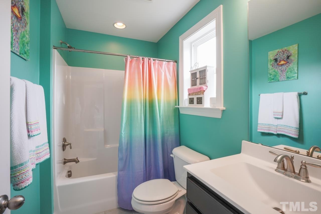 3373 Willow Green Drive Apex, NC 27502 - Photo 33 of 42 a bathroom with a sink toilet and shower