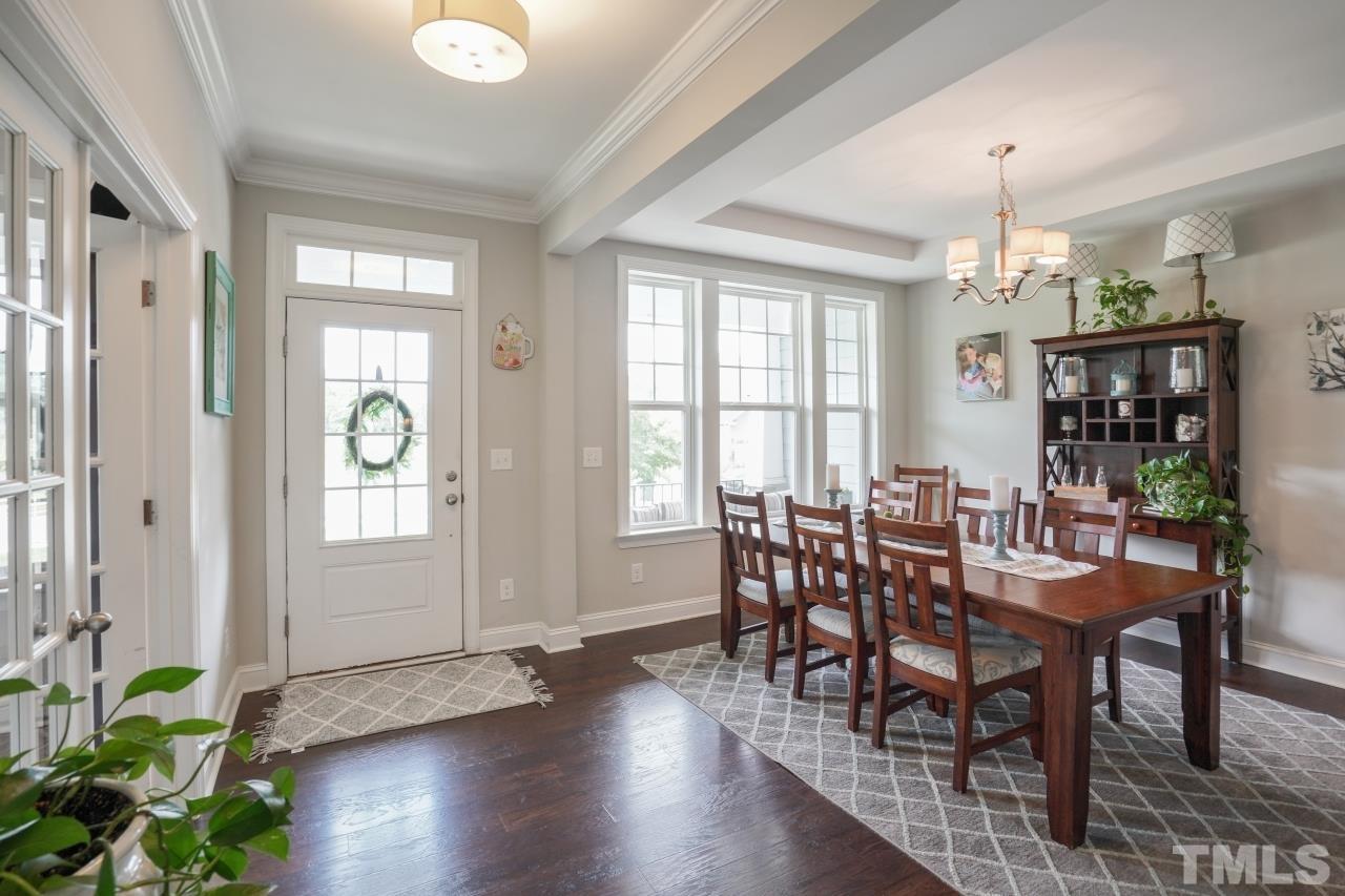 3373 Willow Green Drive Apex, NC 27502 - Photo 4 of 42 a view of a dining room with furniture window and wooden floor