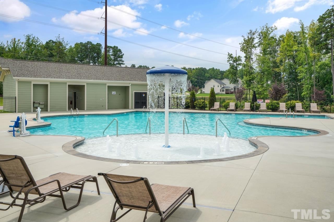 3373 Willow Green Drive Apex, NC 27502 - Photo 42 of 42 a swimming pool with outdoor seating and yard
