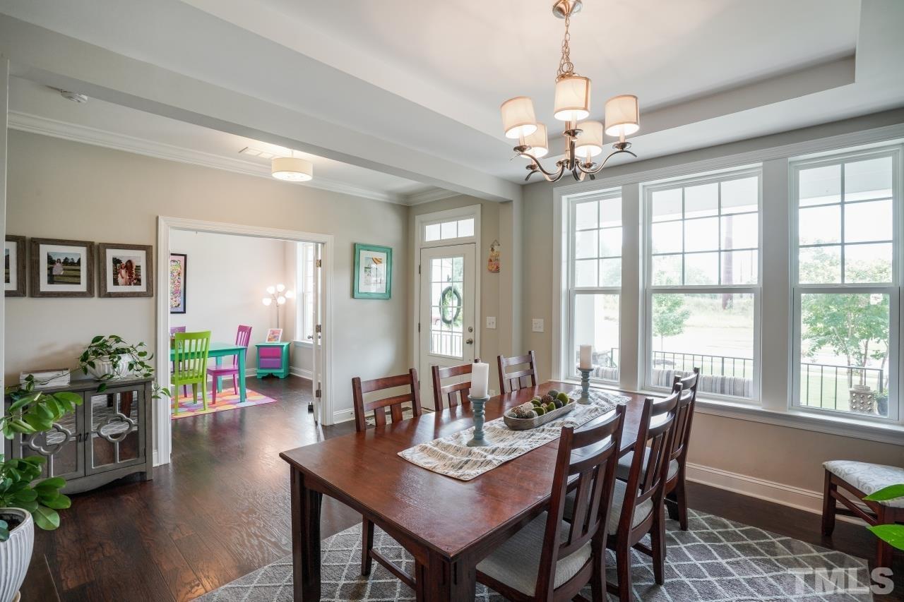 3373 Willow Green Drive Apex, NC 27502 - Photo 5 of 42 a view of a dining room with furniture window and wooden floor