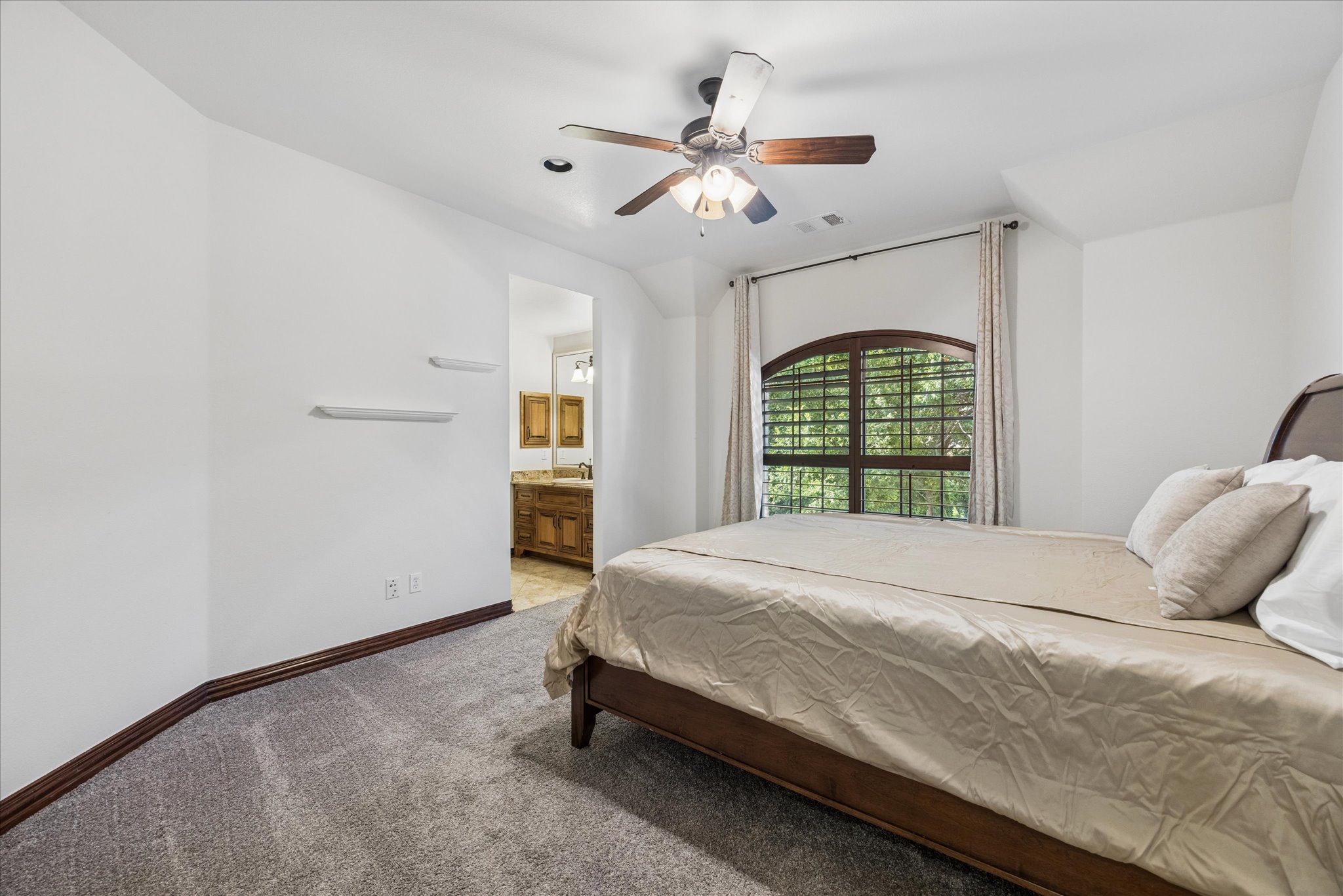11805 Ranchview Court Austin, TX 78732 - Photo 25 of 36 Bedroom featuring neutral carpeting, white walls, and dark wood trim
