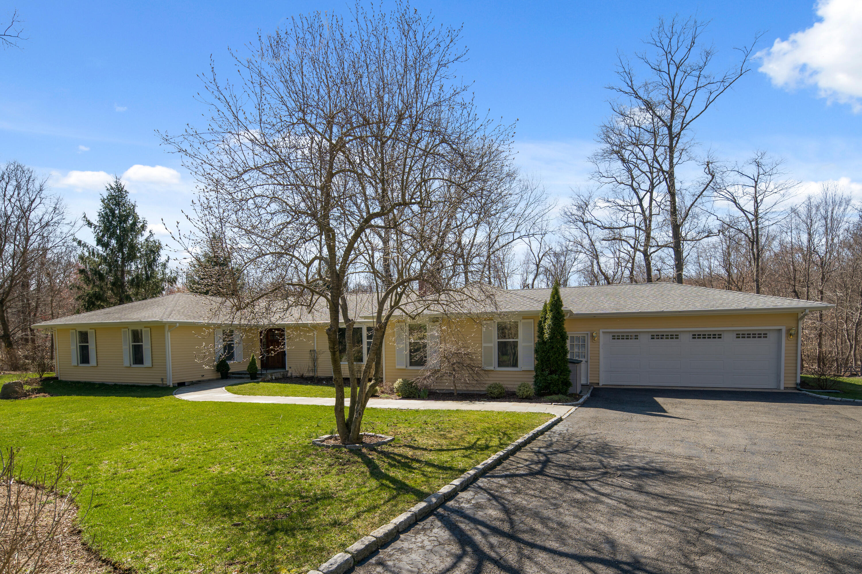 102 Ludlowe Road New Canaan, CT 06840 - Photo 1 of 42 a front view of a house with garden