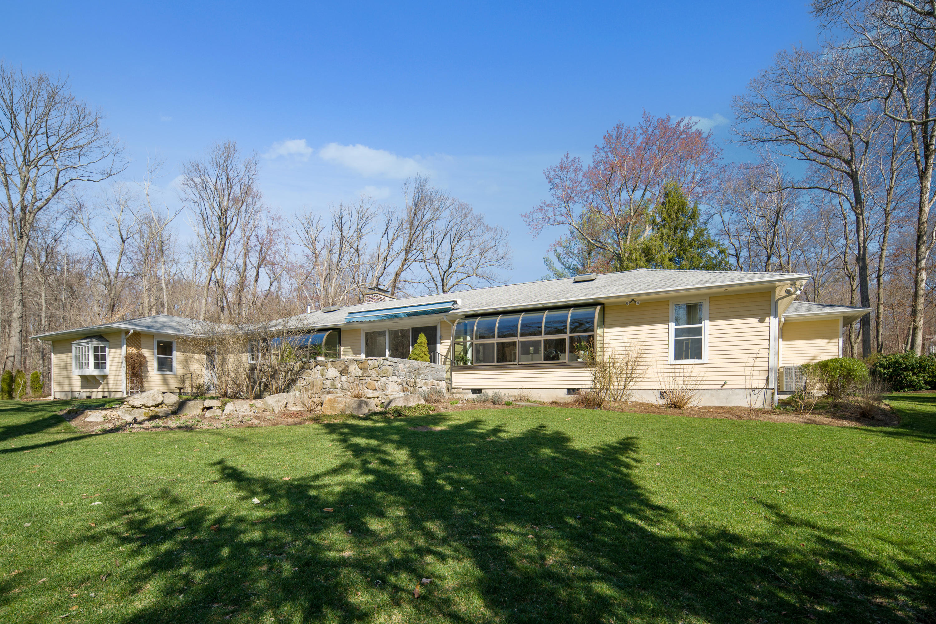 102 Ludlowe Road New Canaan, CT 06840 - Photo 2 of 42 a front view of house with yard and green space