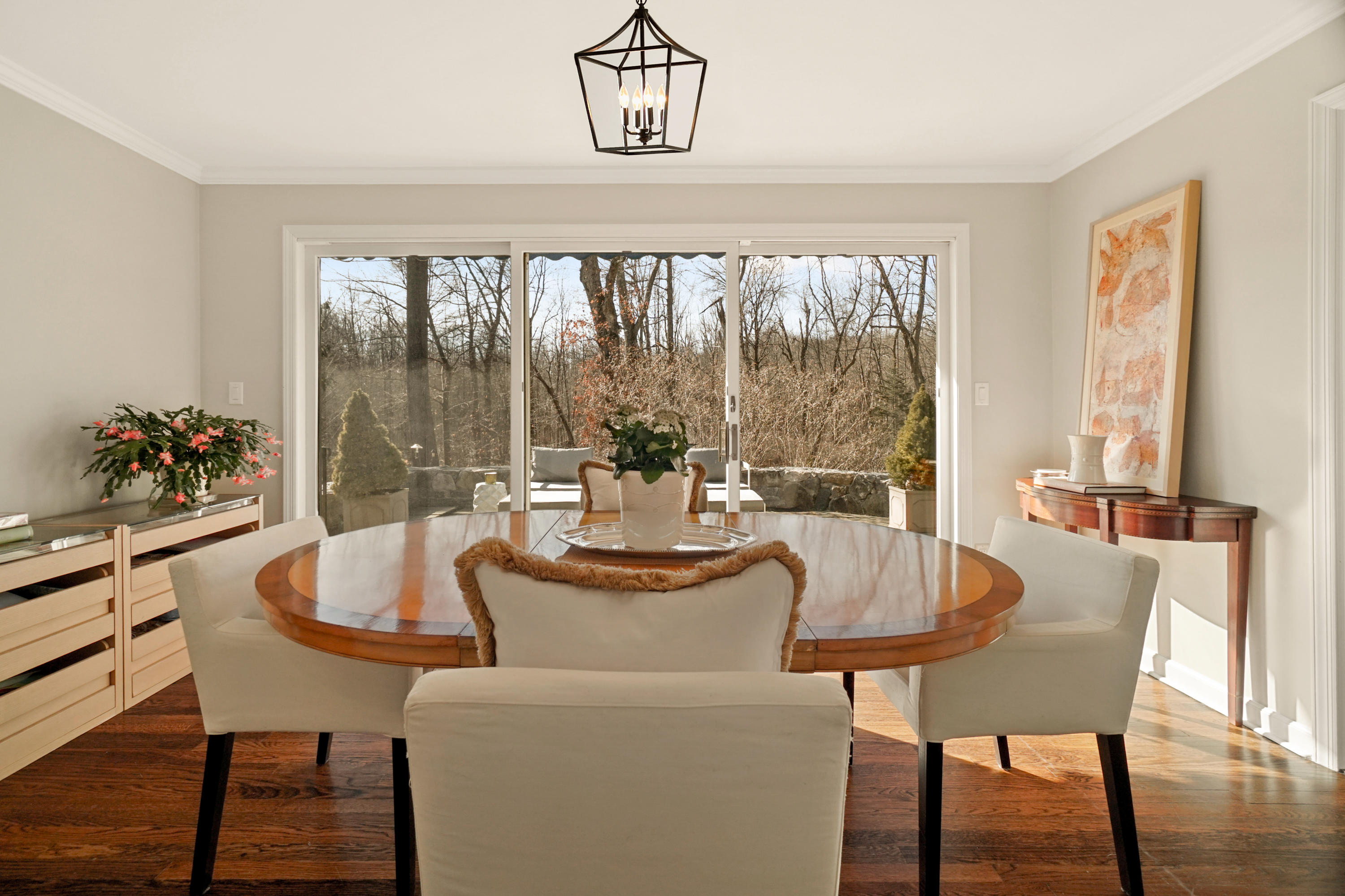102 Ludlowe Road New Canaan, CT 06840 - Photo 19 of 42 a dining room with furniture a chandelier and wooden floor