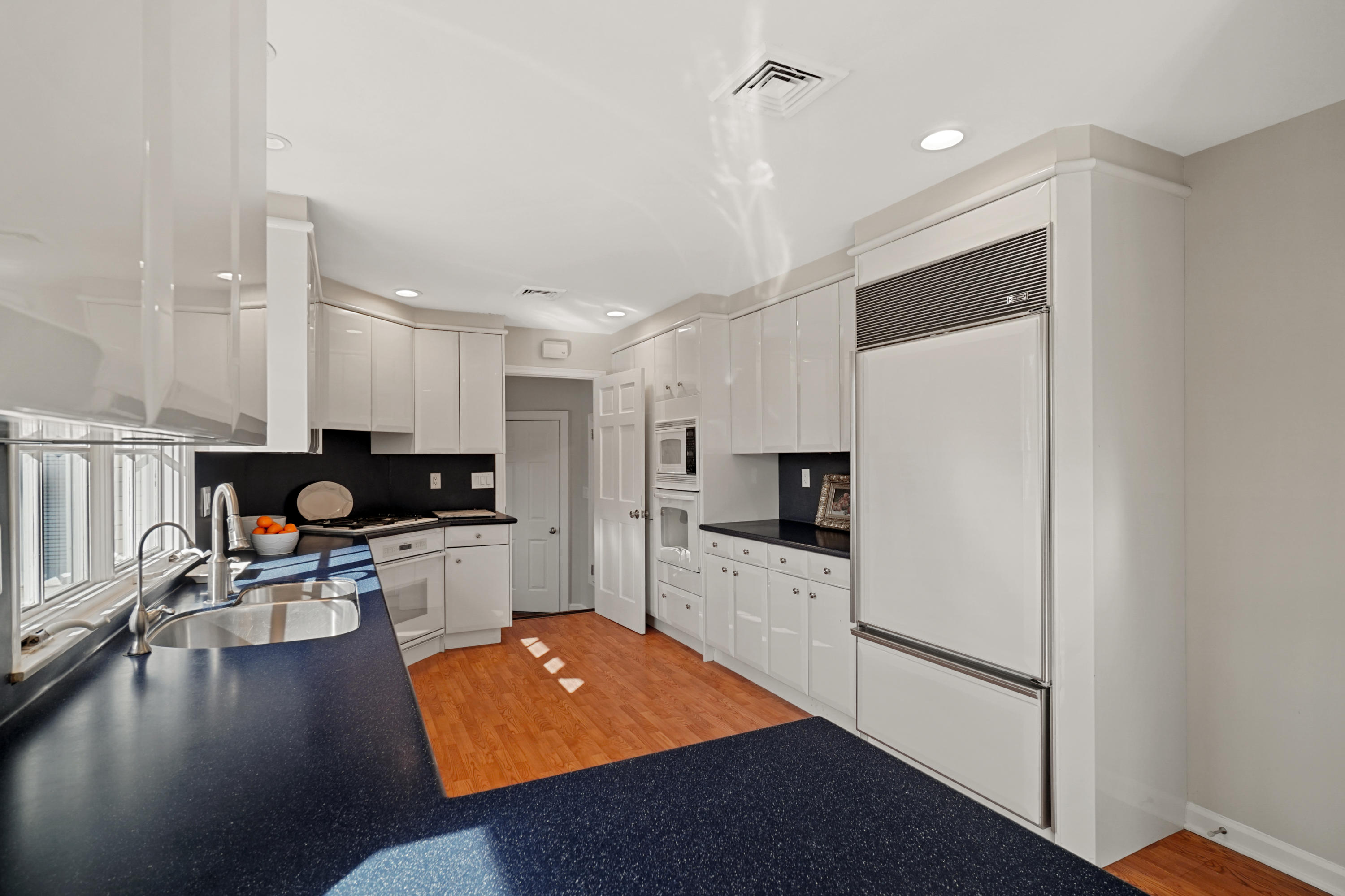 102 Ludlowe Road New Canaan, CT 06840 - Photo 22 of 42 a kitchen with granite countertop a stove a sink a refrigerator and a microwave