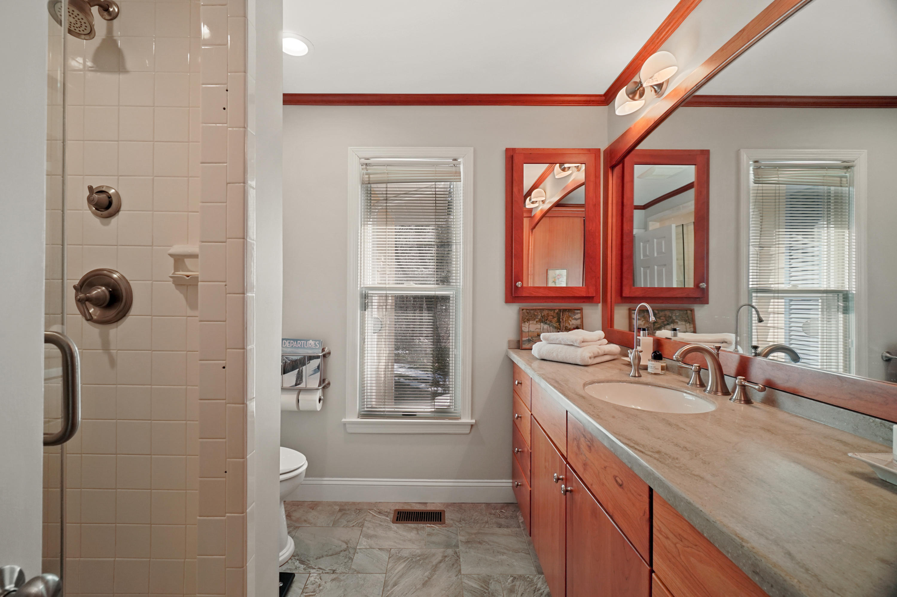 102 Ludlowe Road New Canaan, CT 06840 - Photo 31 of 42 a bathroom with a double vanity sink toilet next to a window