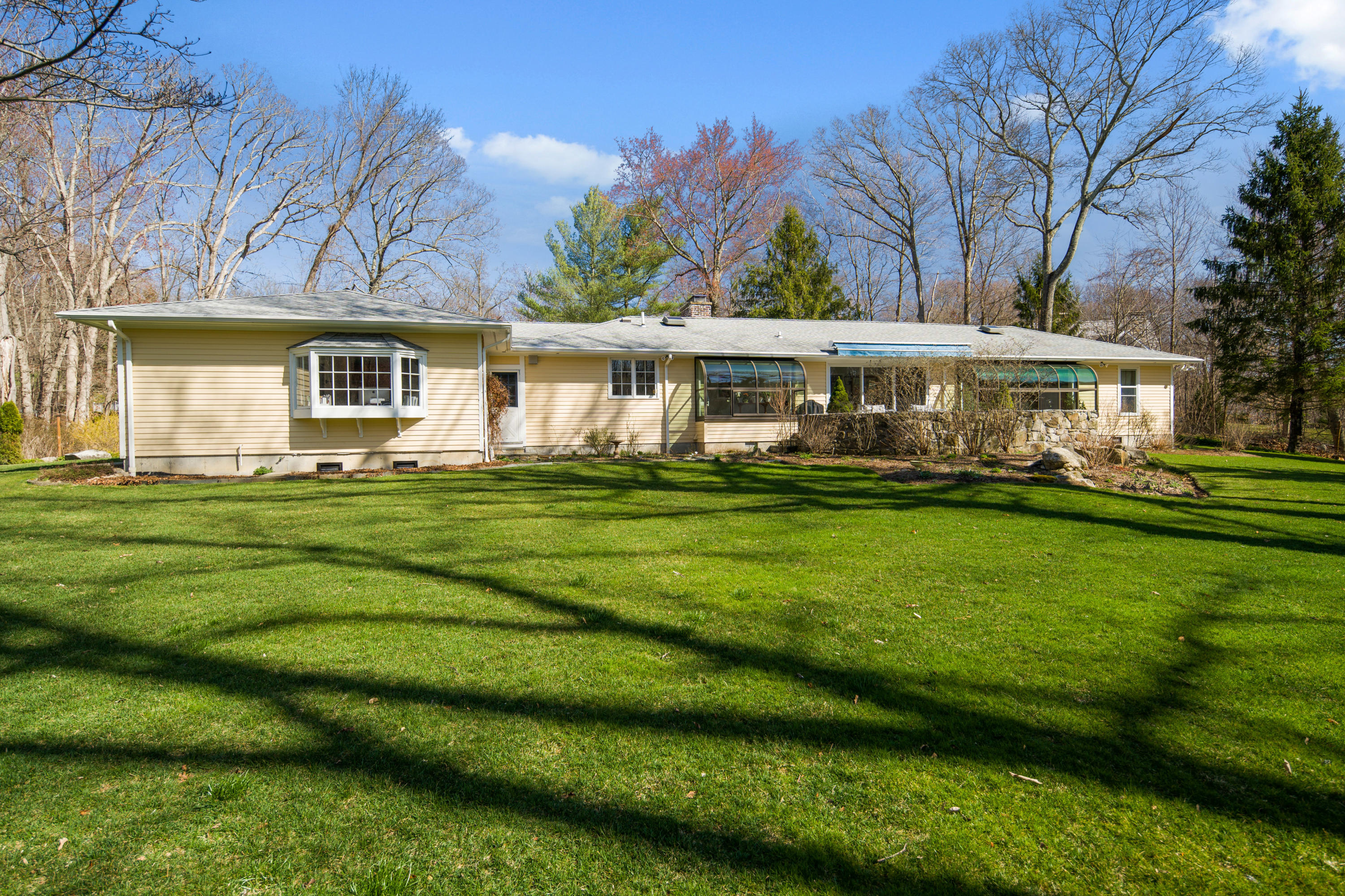 102 Ludlowe Road New Canaan, CT 06840 - Photo 37 of 42 a front view of a house with a garden