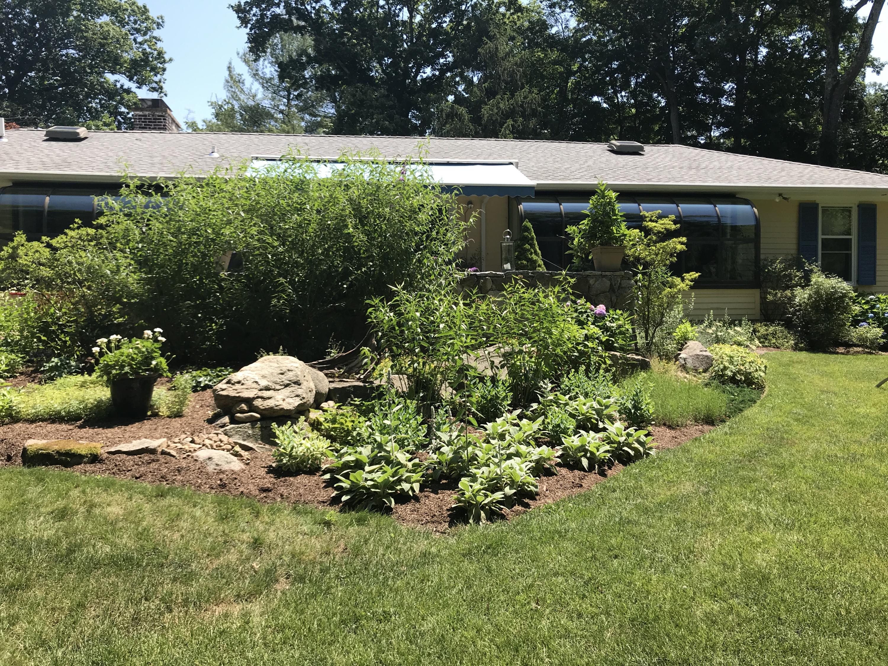 102 Ludlowe Road New Canaan, CT 06840 - Photo 40 of 42 a view of a house with a yard and garden