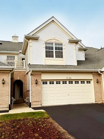 a view of a house with a yard and garage