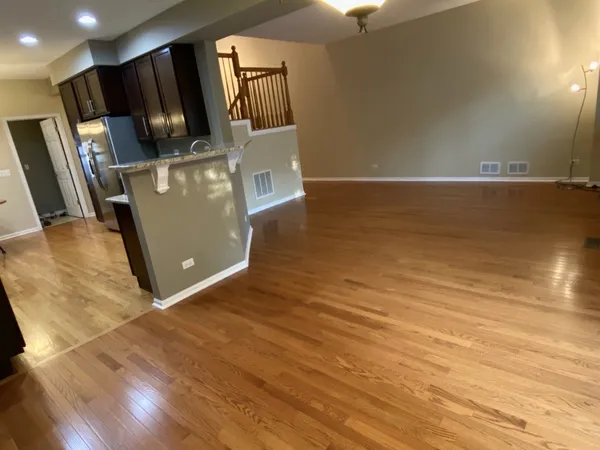 a view of kitchen with stainless steel appliances wooden floor