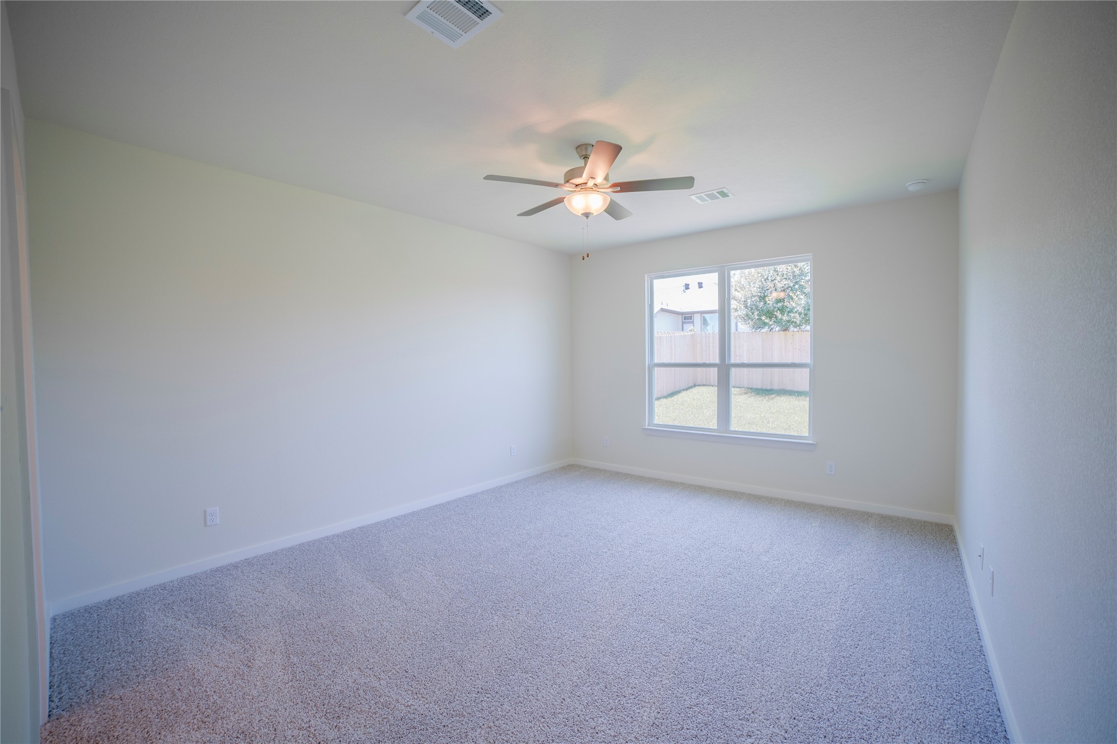 1402 Lk Rdg Drive Brenham, TX 77833 - Photo 24 of 35 an empty room with a window and a ceiling fan