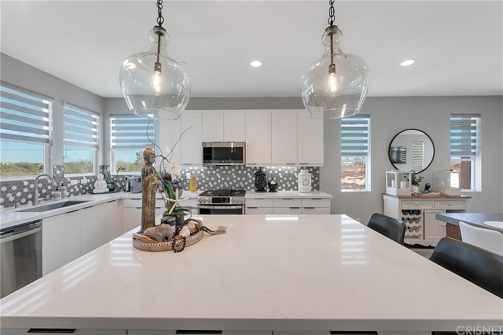 1051 Canal Street Oxnard, CA 93035 - Photo 14 of 37 a large kitchen with a large counter top appliances and cabinets