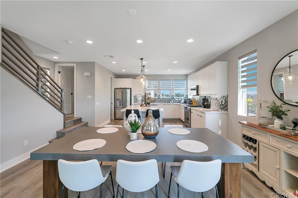 1051 Canal Street Oxnard, CA 93035 - Photo 17 of 37 a view of a dining room with furniture and wooden floor