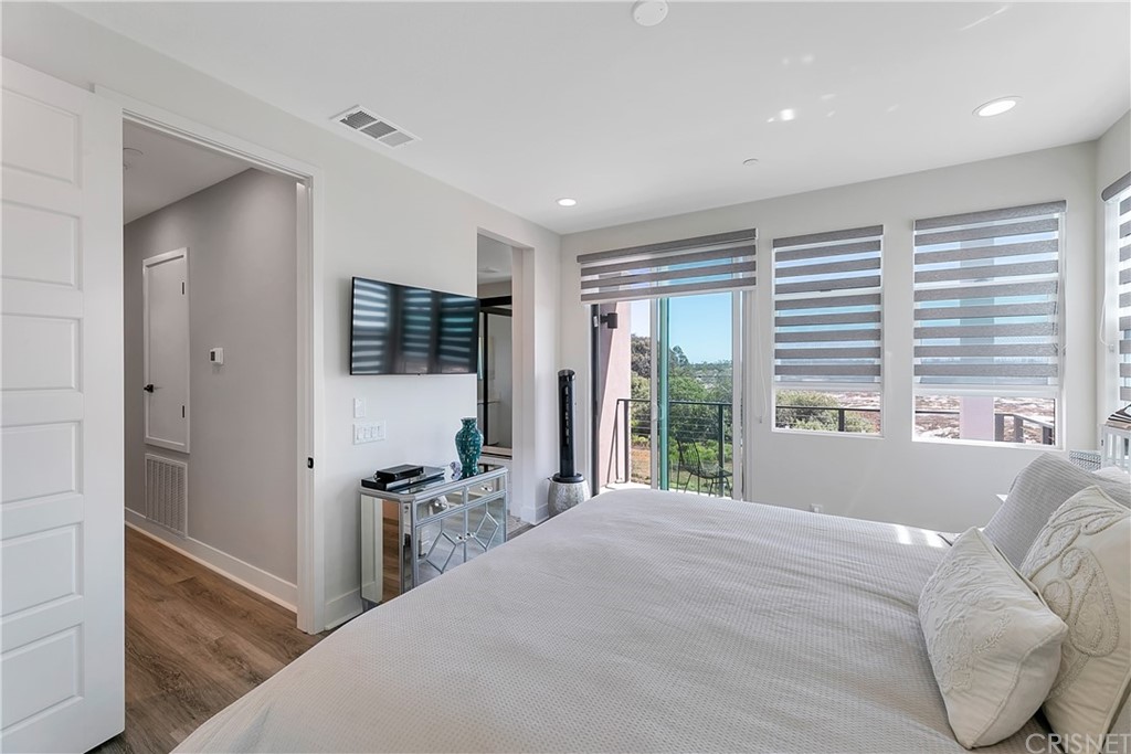 1051 Canal Street Oxnard, CA 93035 - Photo 22 of 37 a bedroom with a large bed and a large window