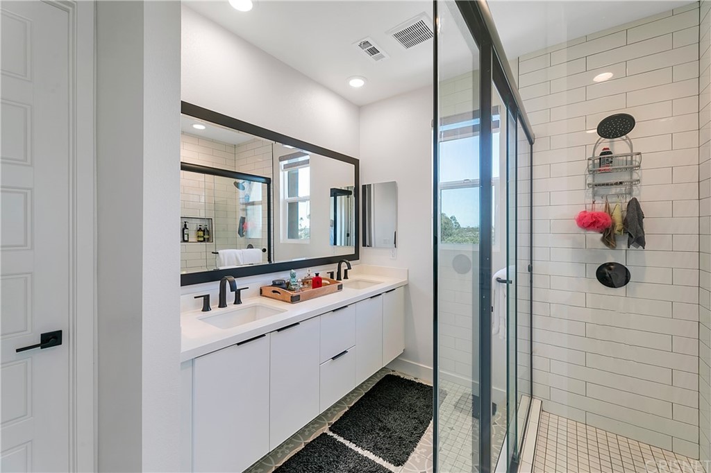 1051 Canal Street Oxnard, CA 93035 - Photo 24 of 37 a bathroom with a mirror sink and glass door