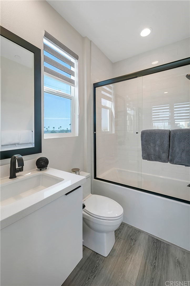 1051 Canal Street Oxnard, CA 93035 - Photo 27 of 37 a bathroom with a sink a toilet and mirror