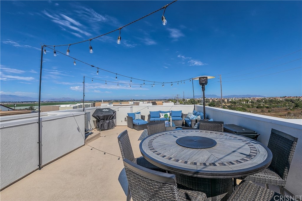 1051 Canal Street Oxnard, CA 93035 - Photo 7 of 37 a kitchen with a sink a stove and chairs
