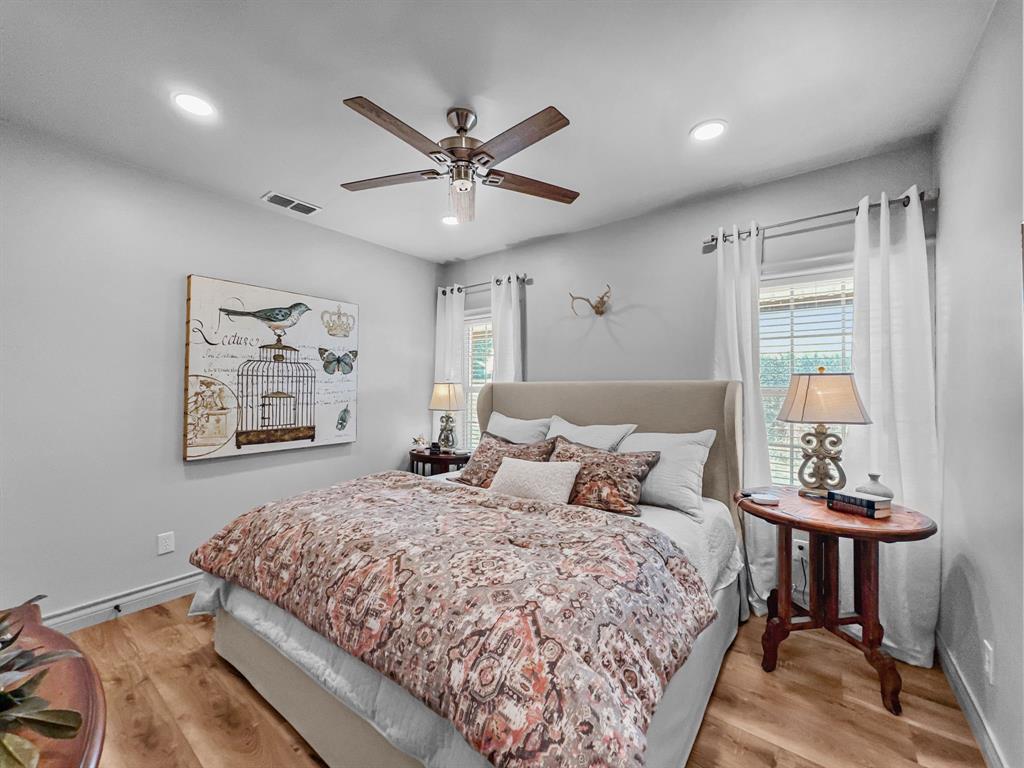 5013 Hells Gate Loop Strawn, TX 76475 - Photo 15 of 33 a bedroom with a bed and a chandelier