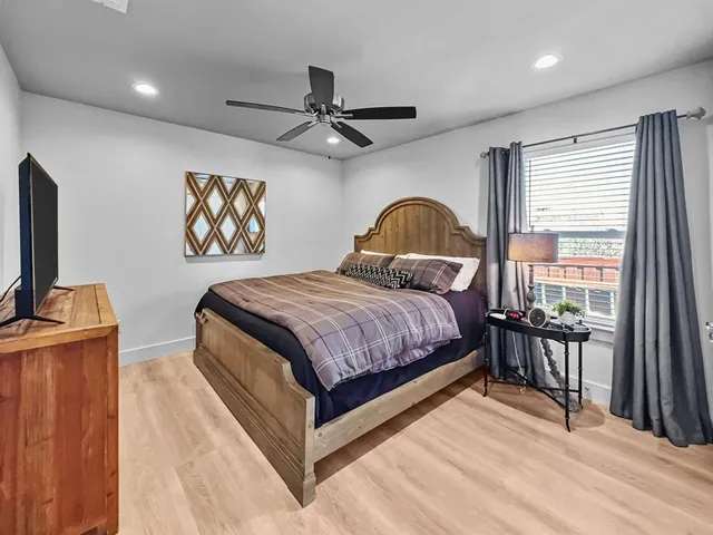 a bedroom with a bed and a flat screen tv